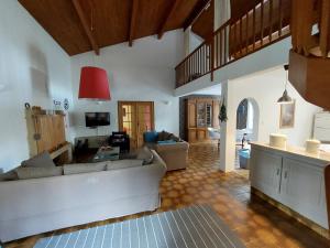 a living room with a couch and a table at Maison Lavande in Sousceyrac