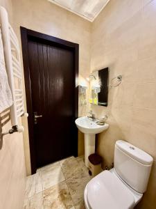 a bathroom with a toilet and a sink at Hotel Vera View in Tbilisi City +43 photos