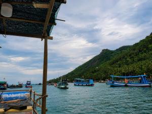 a group of boats in the water on a river at Cactos Floating House Experience on Island in Lai Sơn