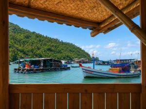 two boats are docked in a body of water at Cactos Floating House Experience on Island in Lai Sơn