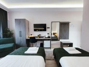 a hotel room with two beds and a kitchen at Tiona in Nova Gradiška