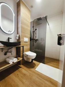 a bathroom with a toilet and a sink and a shower at Tiona in Nova Gradiška