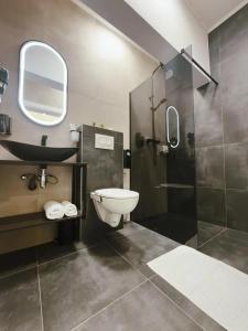 a bathroom with a toilet and a sink and a shower at Tiona in Nova Gradiška +21 photos