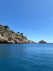 an island in the middle of a large body of water at Hugo Experience - Taormina boat tour in Taormina