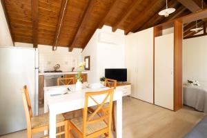 a kitchen and dining room with a white table and chairs at TRAIN HOUSE in Treviso
