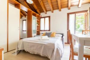 a bedroom with a bed in a room with windows at TRAIN HOUSE in Treviso