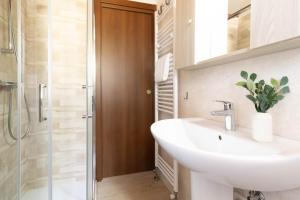 a bathroom with a sink and a shower at TRAIN HOUSE in Treviso +15 photos