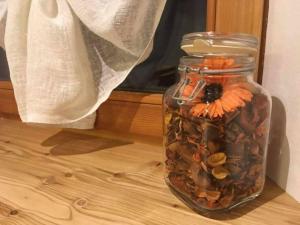a glass jar filled with shells and a flower in it at Lo Péyo Avise in Avise