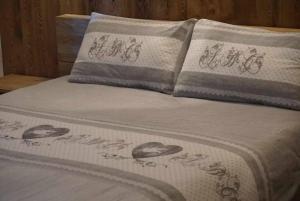 a bed with two pillows on top of it at Lo Péyo Avise in Avise