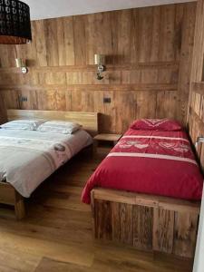a bedroom with a bed and a wooden wall at Lo Péyo Avise in Avise +25 photos