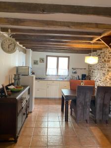 a kitchen with a table and a dining room at Liabaquet Gîtes in Sarlande