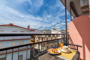 a cup of coffee and a plate of food on a balcony at B&B Cardedu in Cardedu
