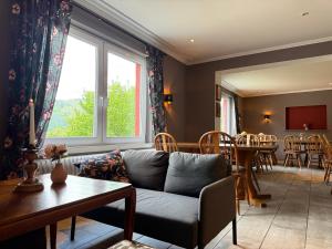 a living room with a couch and a table at Hotel Markgräfler Hof in Badenweiler