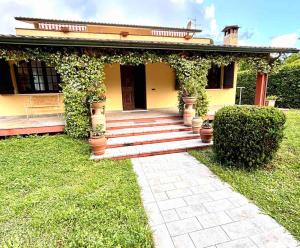 a house with a porch and stairs in front of it at Villa Felicità in Lucca