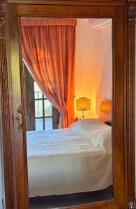 a bedroom with a window with a bed in it at Villa Felicità in Lucca +24 photos