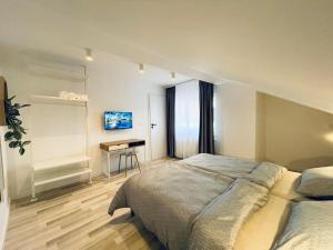 a bedroom with a large bed and a desk at Vila Morariu in Bistriţa +33 photos