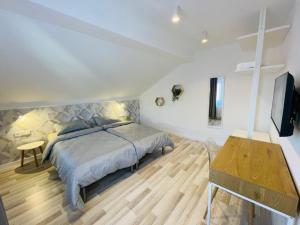 a bedroom with a bed and a television and a table at Vila Morariu in Bistriţa