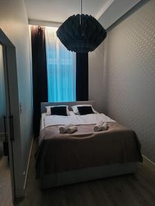 a bedroom with a large bed with slippers on it at apartament centrum-rynek Gorzów in Gorzów Wielkopolski