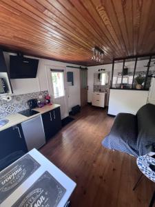 a kitchen and living room in a house at Gîte du Riou Sec in La Roque-Sainte-Marguerite