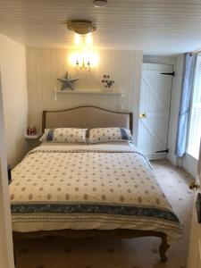 a bedroom with a bed with a star on the wall at Samphire in Padstow