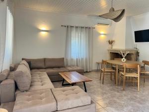 a living room with a couch and a table at Villa Delphini in Argyrátika
