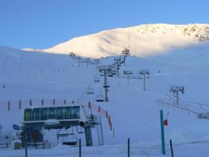 a ski lift on top of a snow covered mountain at La Bergerie in Saint-Lary-Soulan