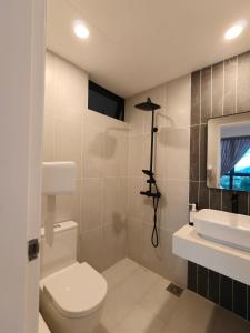 a bathroom with a toilet and a sink at Milano8 Condominium Opposite Vivacity in Kuching +20 photos