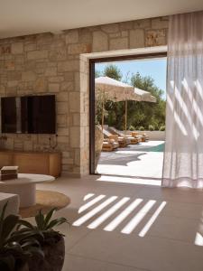 a living room with a large sliding glass door at Alba d'Oro in Laganas