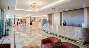 a lobby of a shopping mall with a reception counter at Golden Sands Golf Resort in Hue