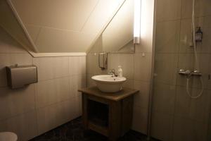 a bathroom with a sink and a shower at Trasti & Trine Boutique Hotel in Alta