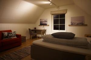 a bedroom with a bed and a desk and a window at Trasti & Trine Boutique Hotel in Alta