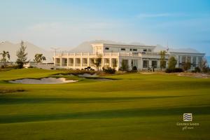 a view of a golf course with a large building at Golden Sands Golf Resort in Hue