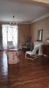 a living room with a chair and a table at La vie en couleur in Clohars-Carnoët