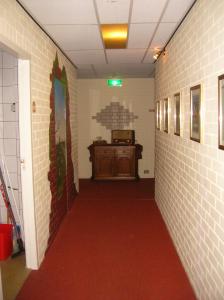 JipsinghuizenにあるHotel de Waalehofの赤い床と壁の廊下