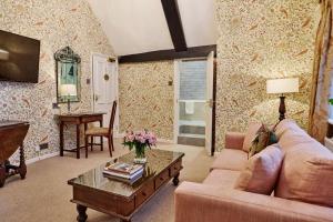 a living room with a couch and a table at Ockenden Manor Hotel & Spa in Cuckfield