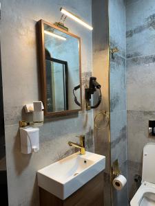 a bathroom with a sink and a mirror and a toilet at Şah Bey Konağı in Istanbul +52 photos