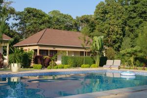 a house with a swimming pool in front of a house at Tanzania Safari Lodge in Arusha +45 photos