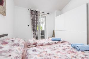 a bedroom with two beds and a window at Apartman Mely in Nova Vas