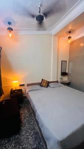 a bedroom with a large bed in a room at Pebbles Guest House Digha in Digha
