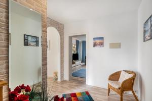 a living room with a chair and a brick wall at Südstadtquartier 108 in Wilhelmshaven