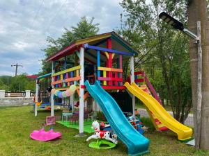 a playground with slides and play equipment in a park at LA STORIA by Camping Mala in Eşelniţa