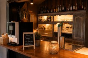 a bar with a counter with a sign on it at Gezellig Chalet Ardennen The Secret View in Amblève +10 photos
