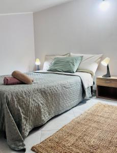 a bedroom with a bed and a rug at Villa Artemide - Ospitalità nel Borgo in Marsico Vetere