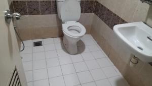 a bathroom with a toilet and a sink at HWKl in Kuala Lumpur +7 photos