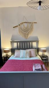 a bedroom with a large bed with a pink blanket at Apartament Wichrowy in Rowy