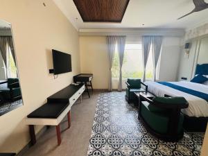 a hotel room with a bed and a television at Hotel Lotus castle in Bathinda