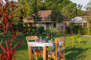 a table and two chairs sitting in a yard at Tanzania Safari Lodge in Arusha
