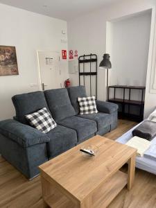 a living room with a couch and a coffee table at Rincon de Toledillo in Plasencia