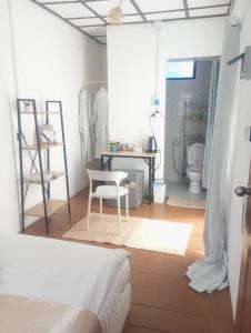 a bedroom with a bed and a desk and a chair at Bird Nest Hostel in Ko Tao +46 photos