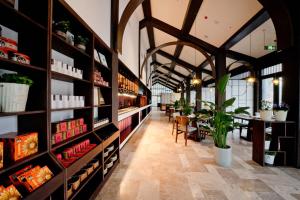 a restaurant with a long aisle with tables and plants at ALOR VALLEY HUZHOU in Huzhou